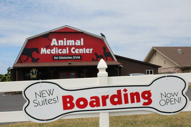 Boarding - Now Open - New Suites sign in front of Animal Medical Center